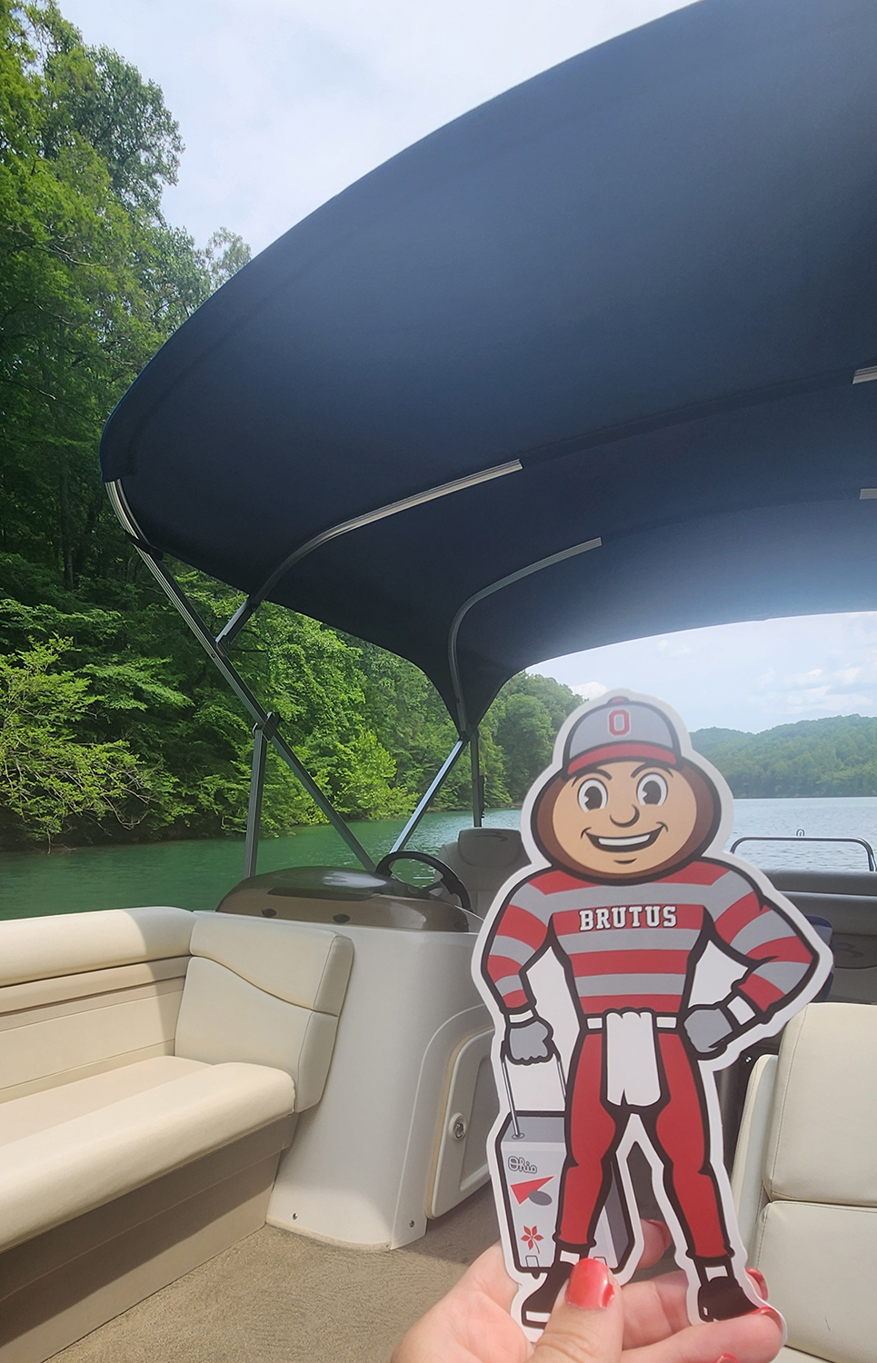 Bruuts on a boat with a lake and trees in background in LaFollette, Tennessee.