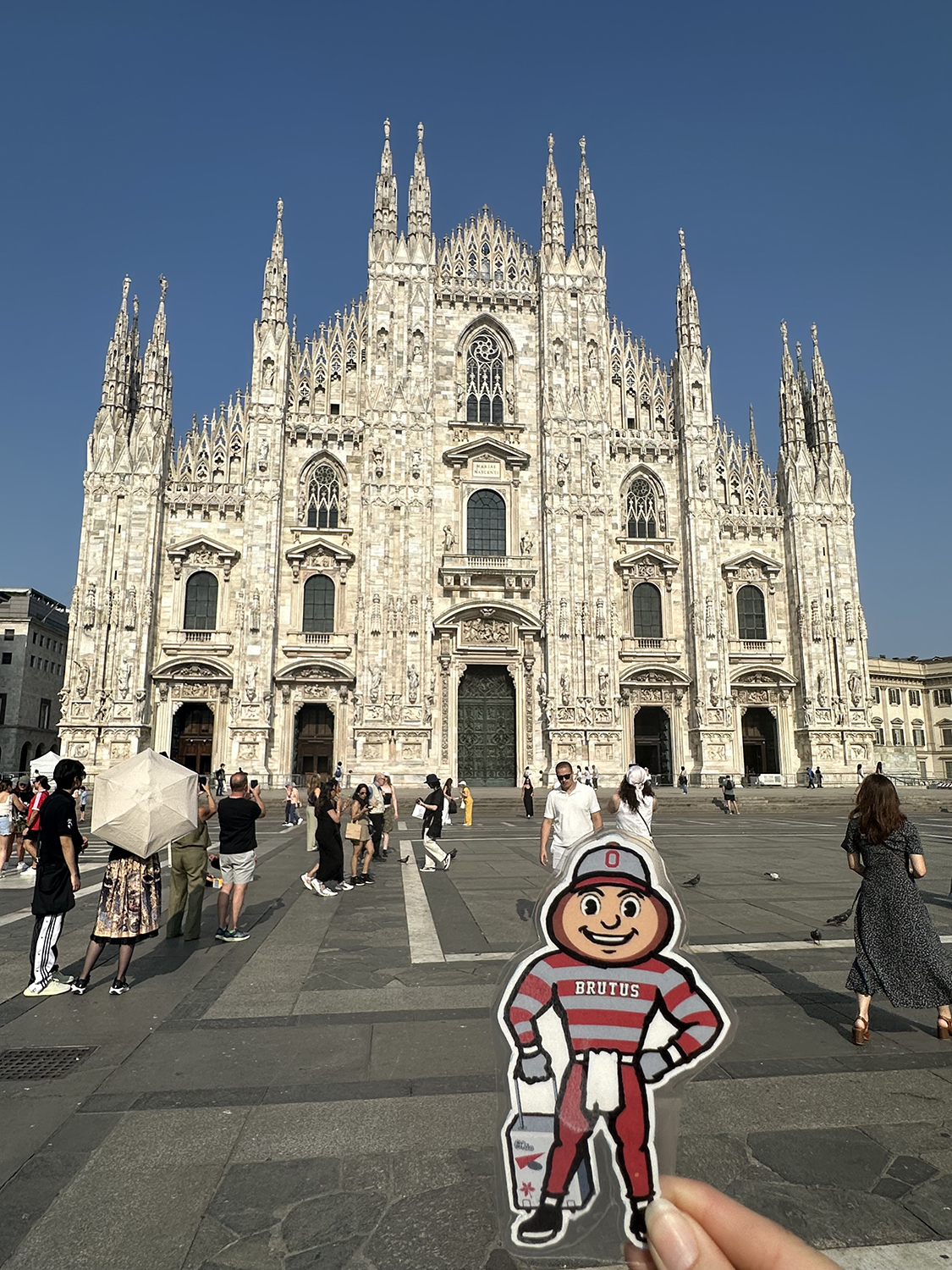 Brutus in front of the Duomo di Milano in Milan, Italy.