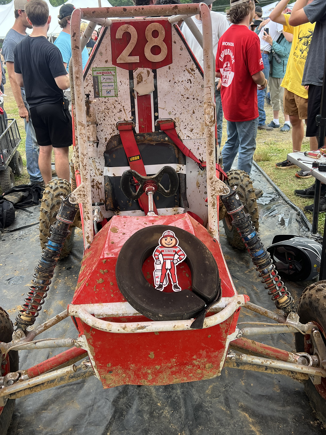 Brutus on the hood of a muddy off-road go-kart in Mechanicsville, Maryland.