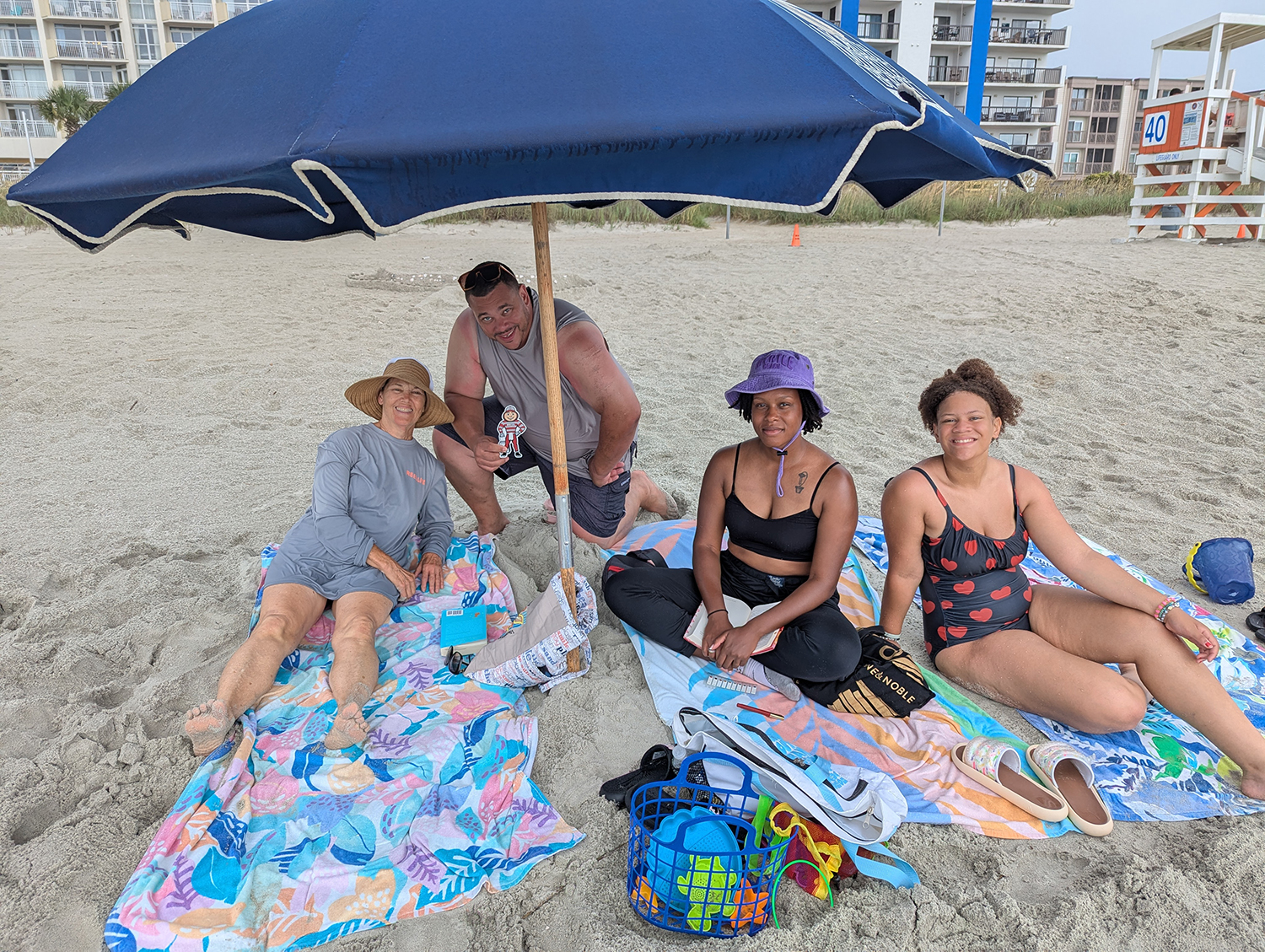 Three women and one man holding Brutus on the beach in Myrtle Beach, South Carolina.