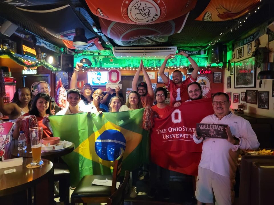 brazil alumni club holding brazil flag and club flag at a game watch