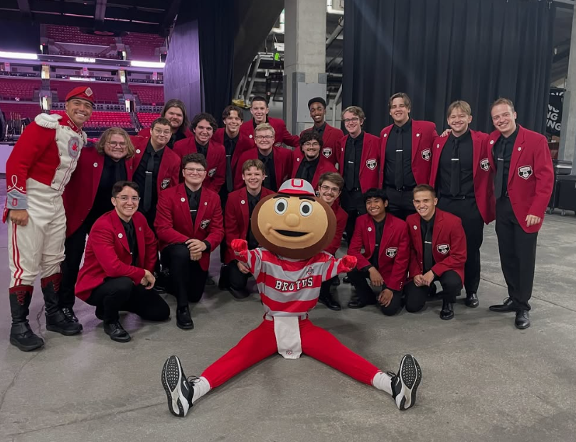 men's glee club members smiling with brutus 