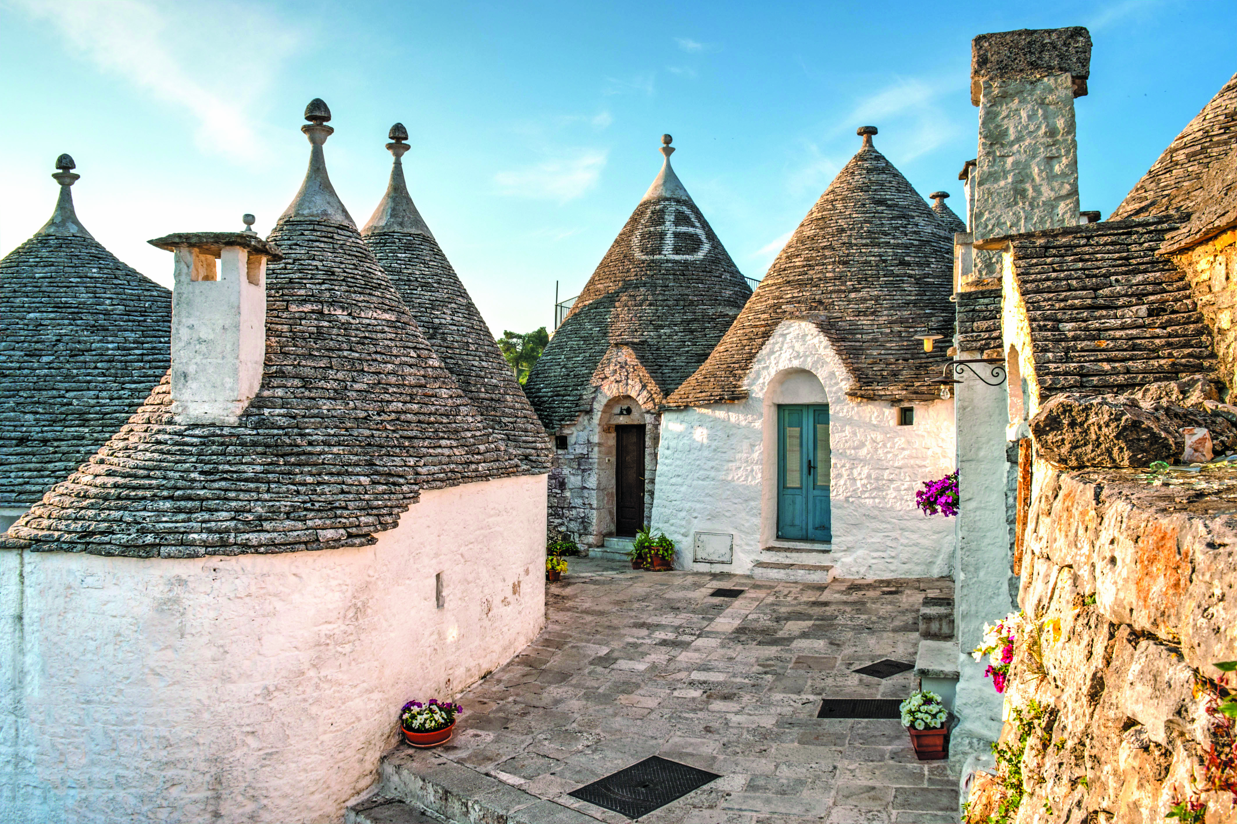 Cluster of traditional trulli houses with conical stone roofs in Alberobello.