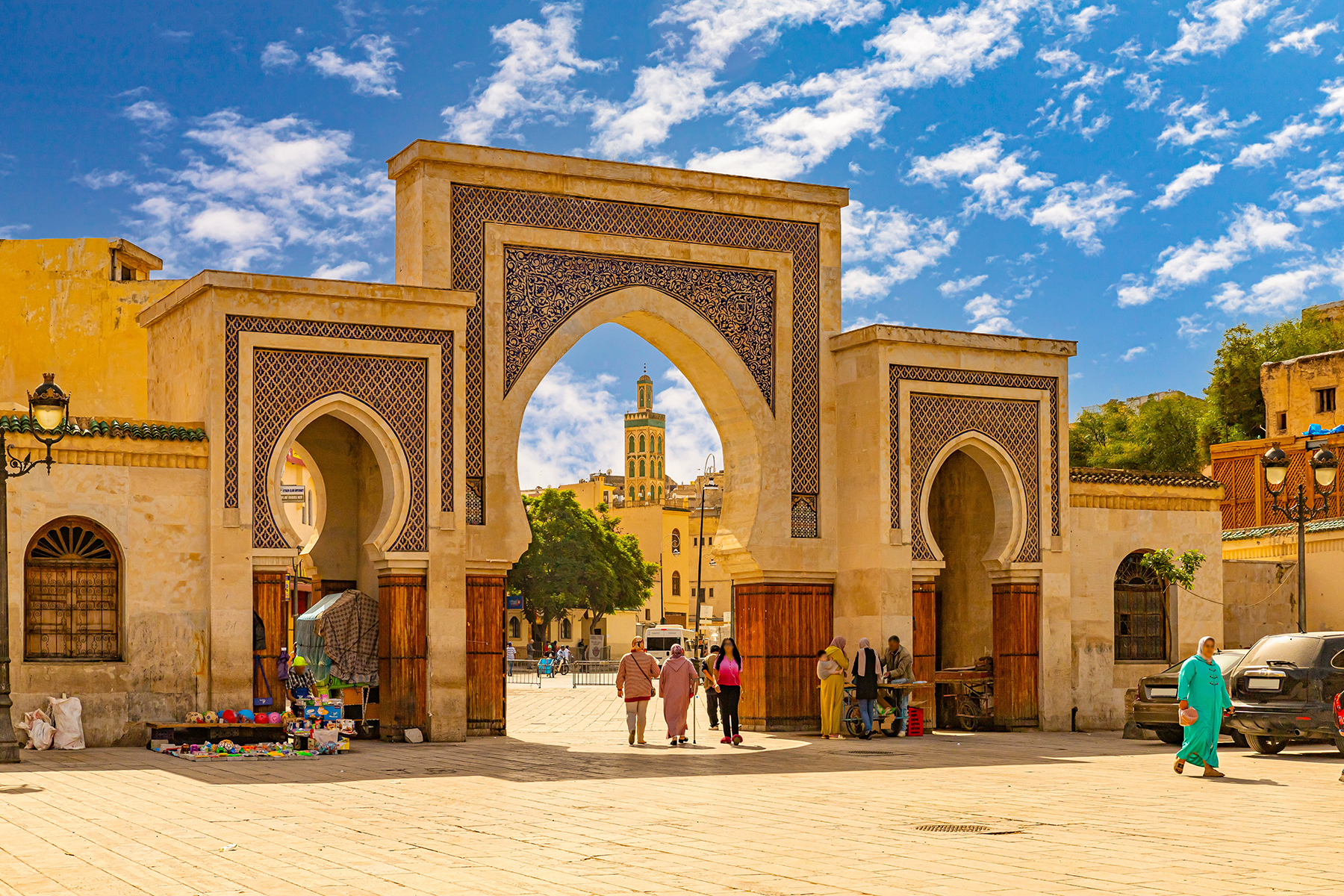 A grand entrance into a city in Fes with bright blue sky in the background 