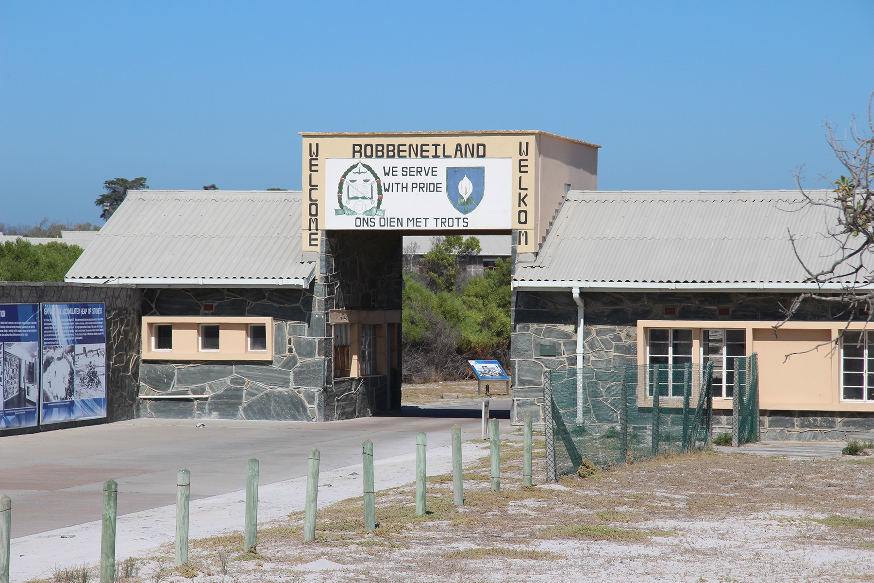 Entrance gate to Robben Island with signage above a stone archway.