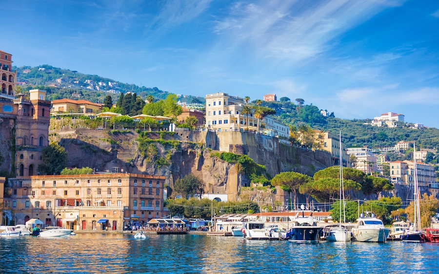 Coastal view of Sorrento and the Gulf of Naples, Italy, featuring dramatic sea cliffs and luxury hotels that draw tourists from around the world.