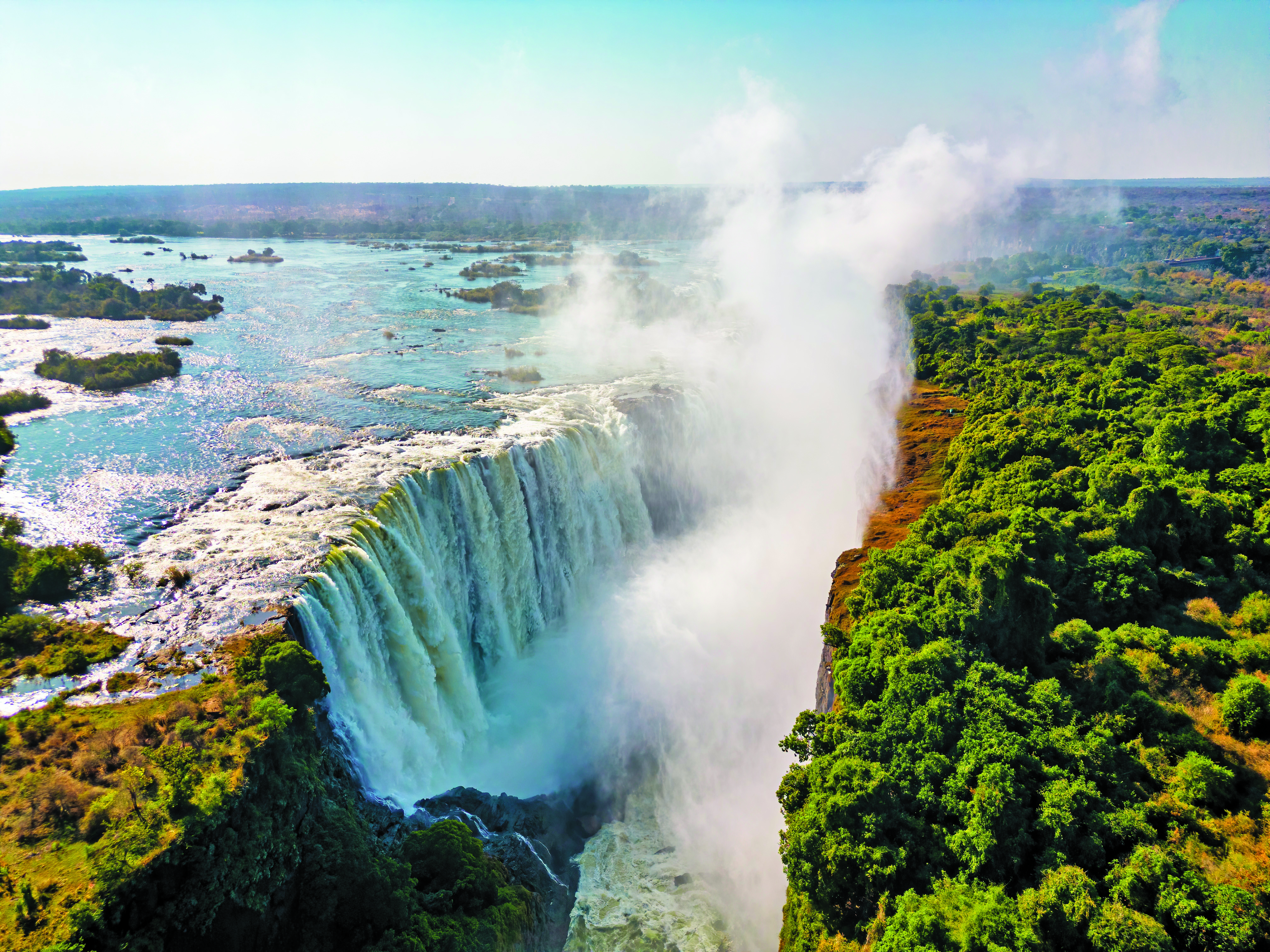 Rocky cliff at Cape Point surrounded by deep blue ocean.