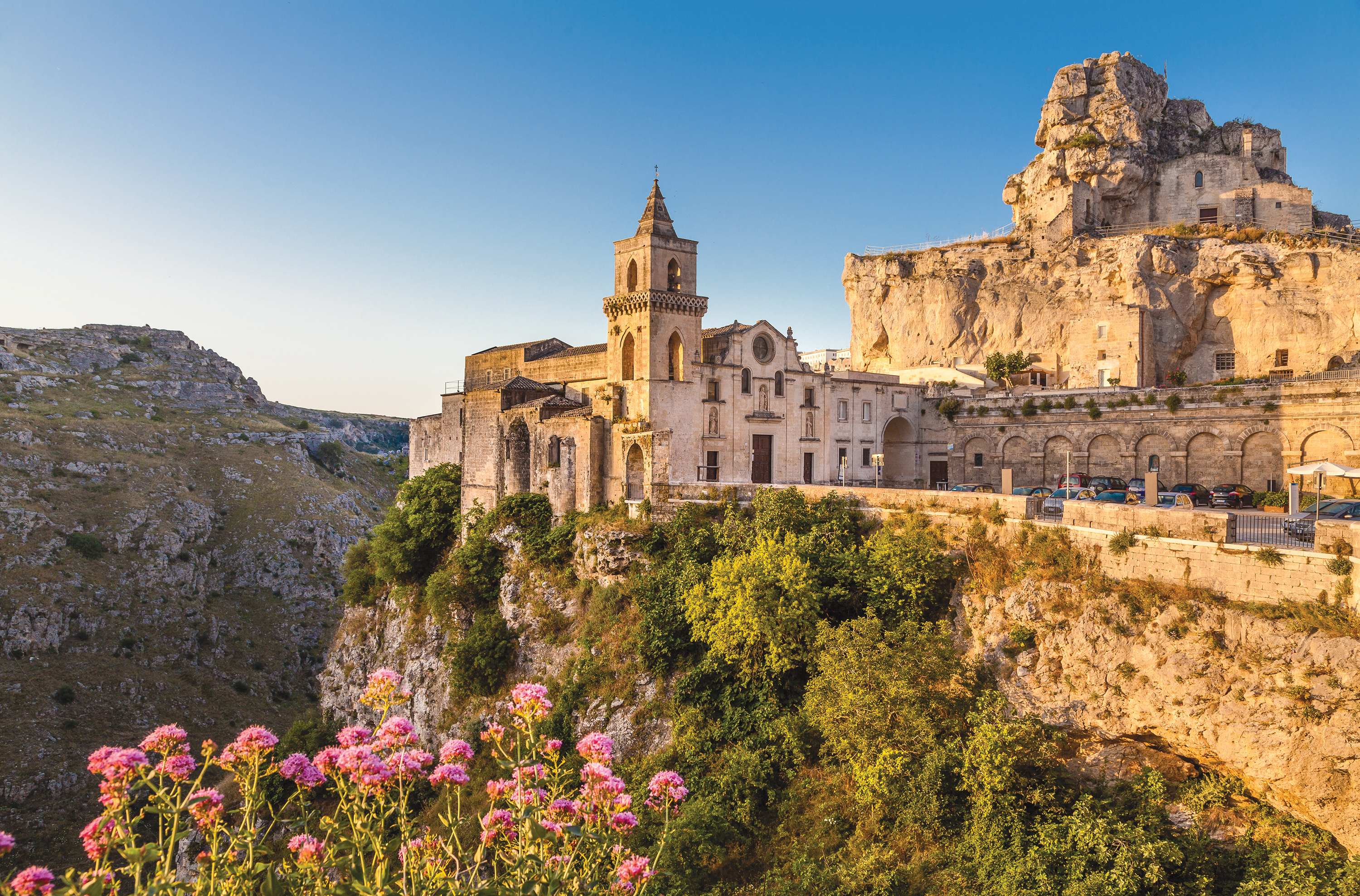 Historic stone churches and buildings perched on cliffs in the Sassi di Matera district.