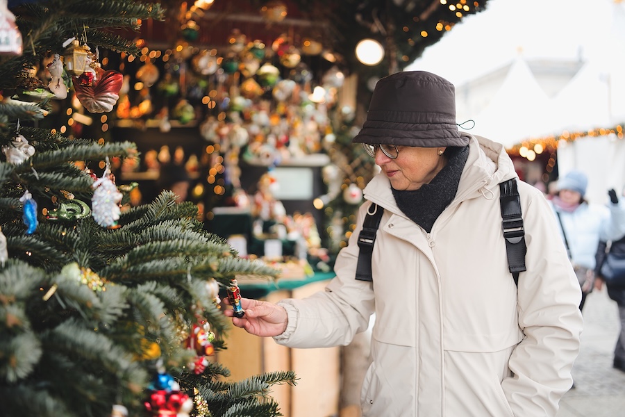 A person shopping during the day at the holiday markets