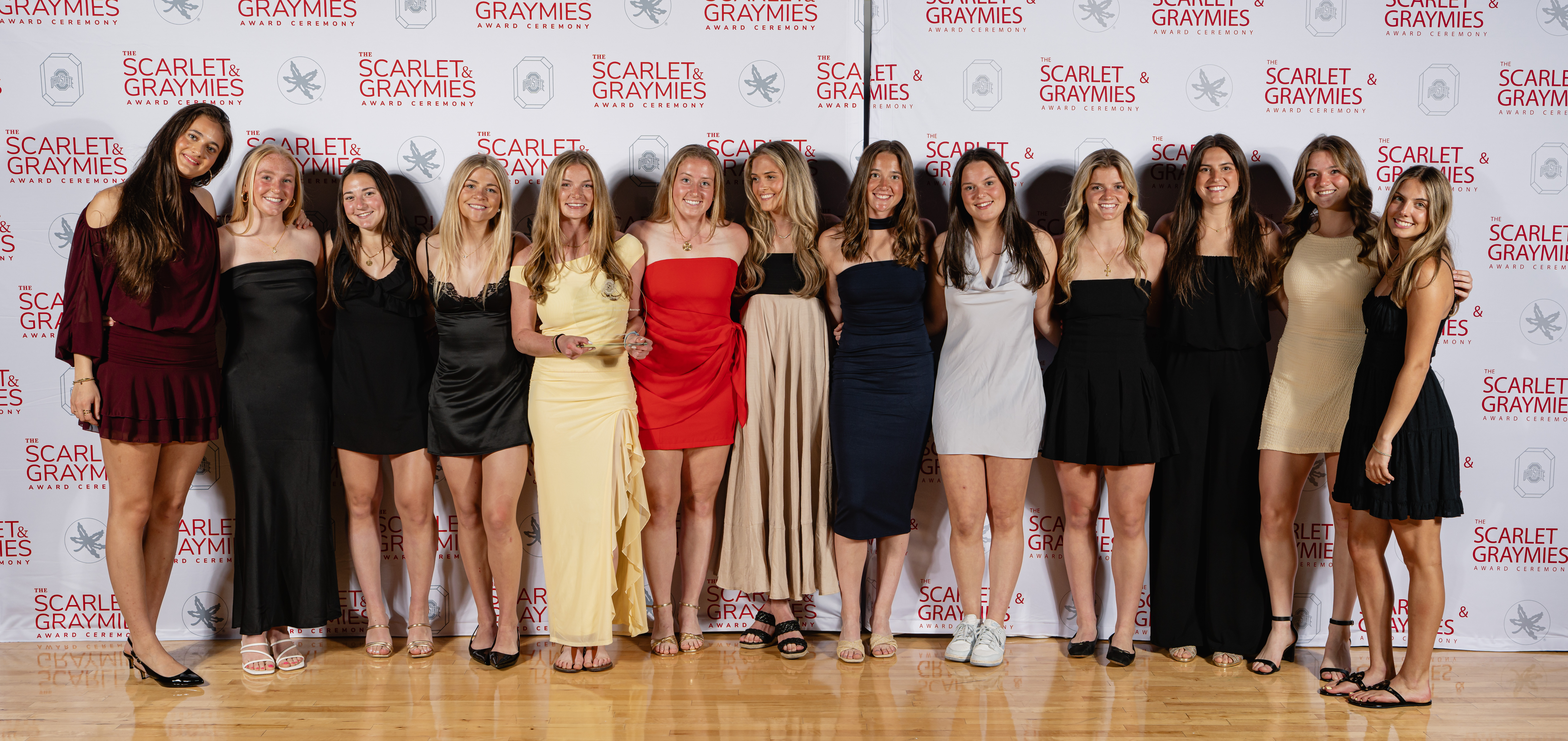 varsity O scholarship winners smiling holding their award 