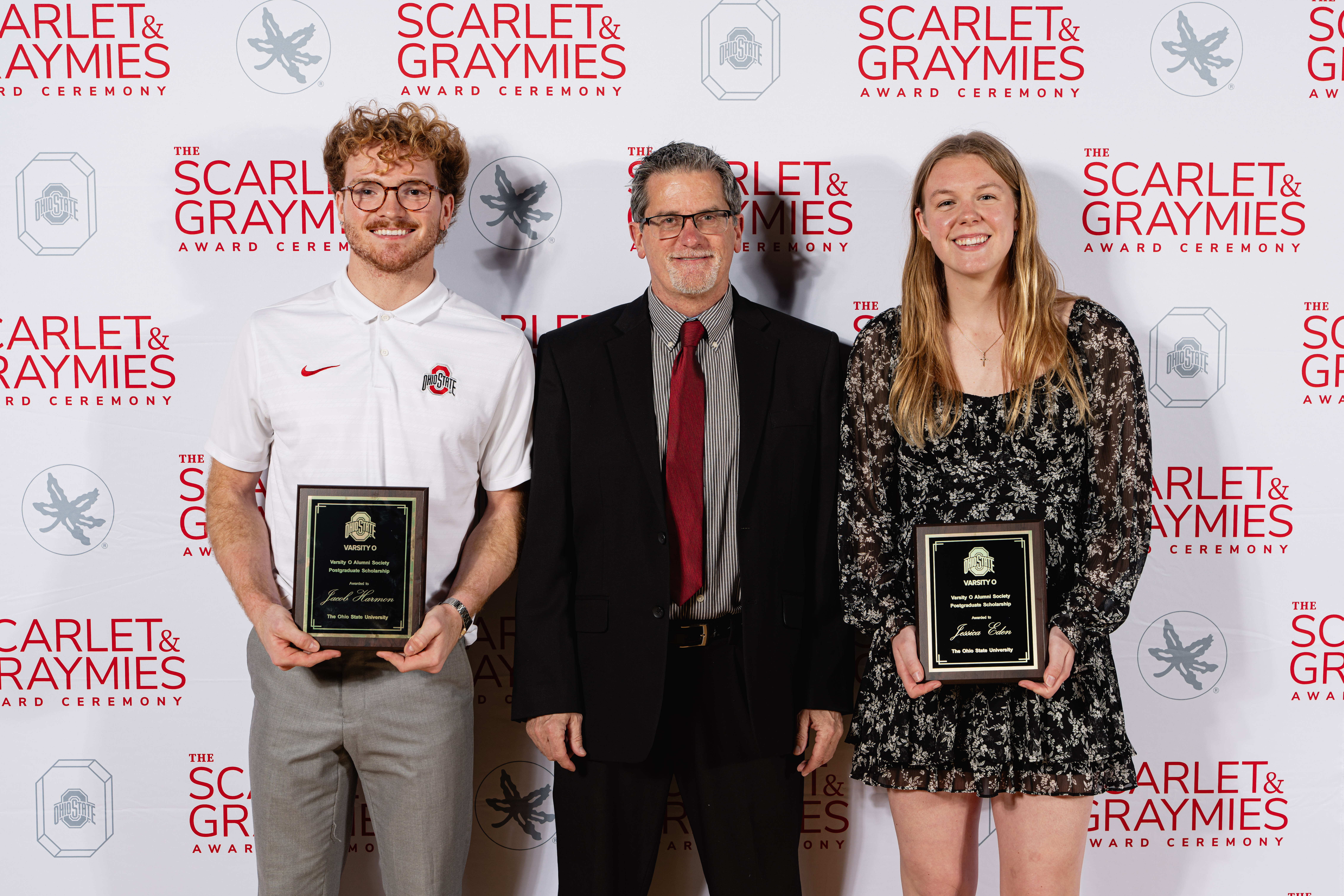 varsity o scholarship winners smiling holding their award