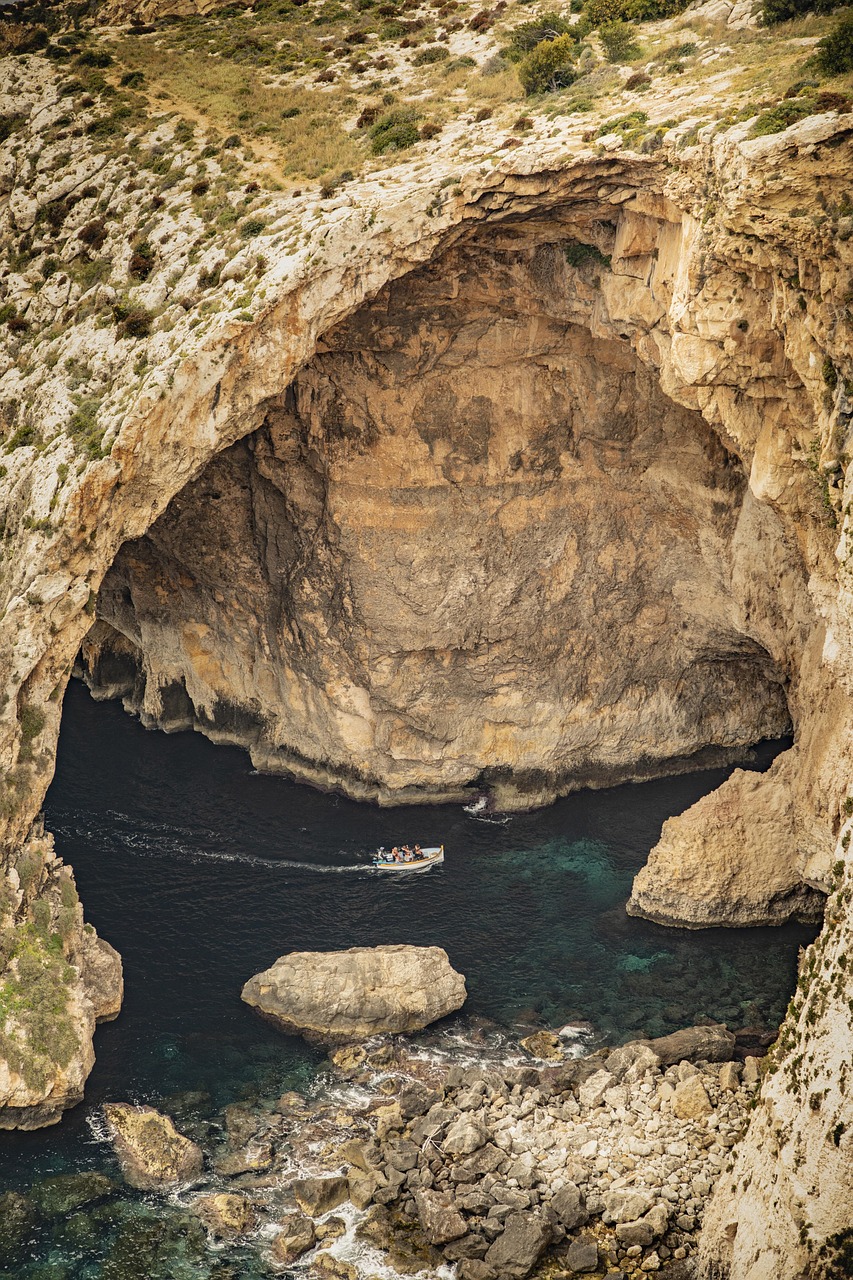 Boat inside the Blue Grotto sea cave on the southern coast of Malta.