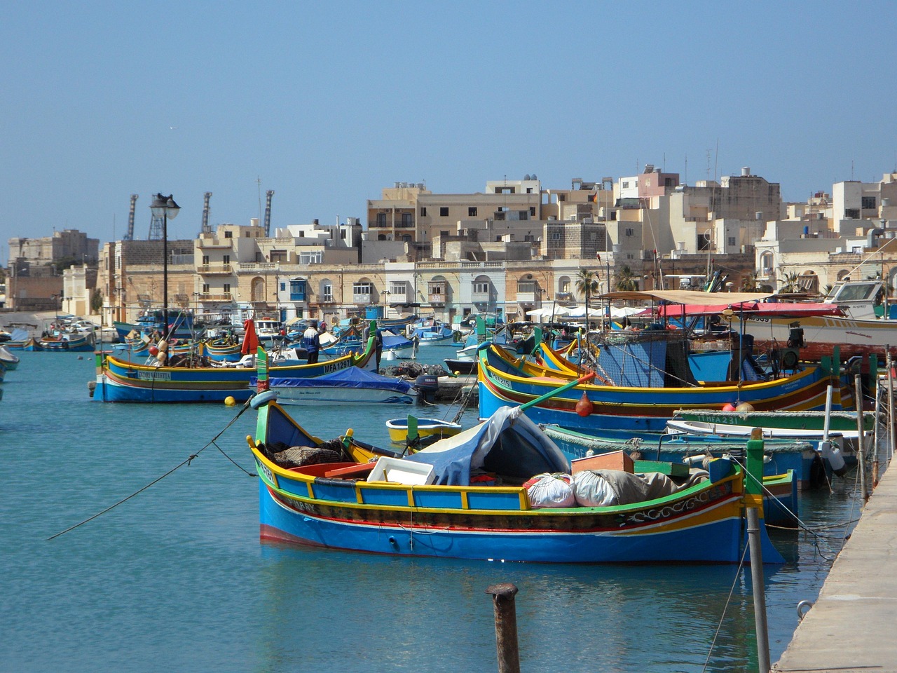 Colorful fishing boats docked in Marsaxlokk harbor, Malta.