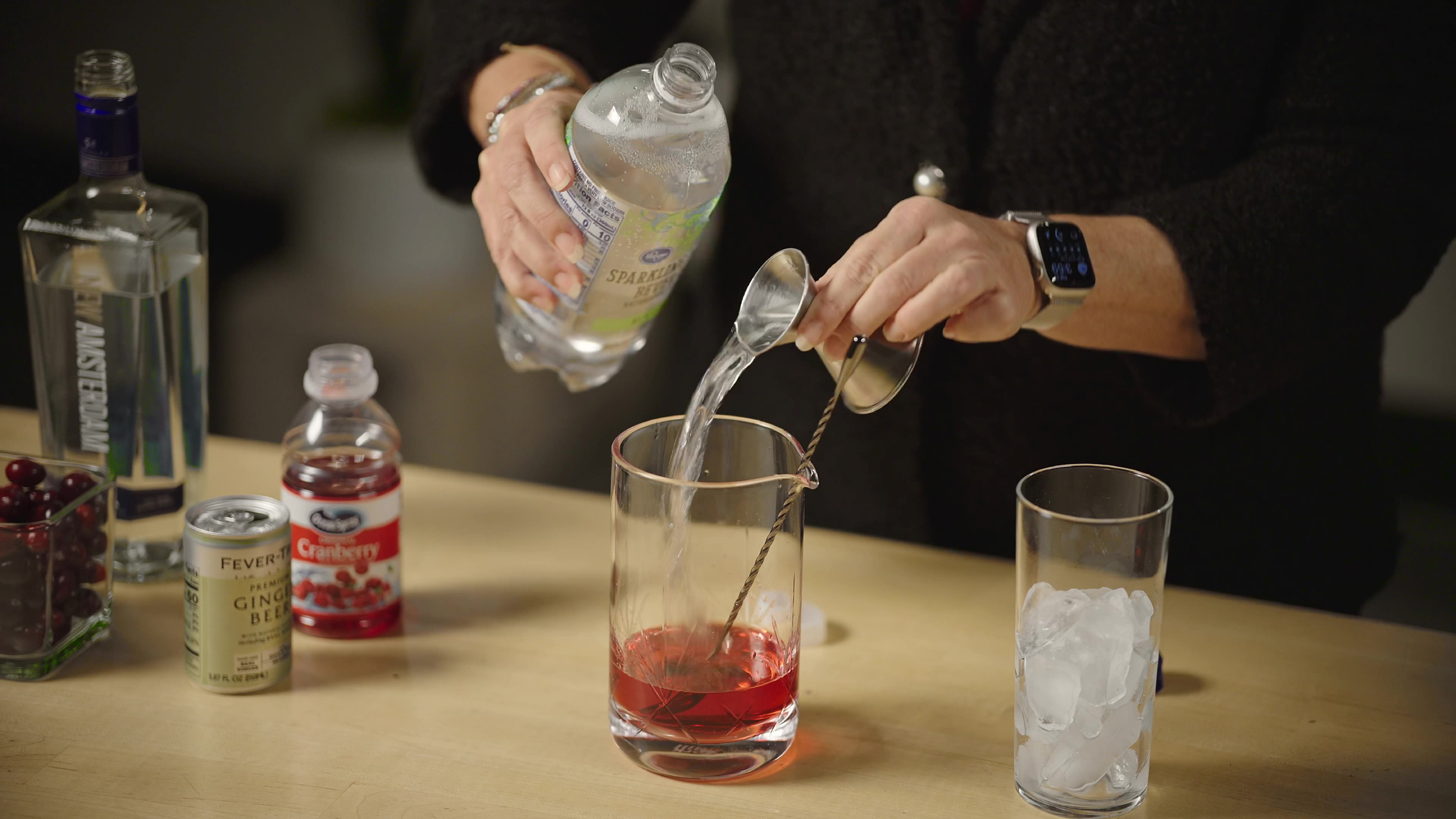molly ranz calhoun is pouring tonic water into a raspberry mixture