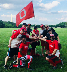 group of softball players holding up an Ohio State flag