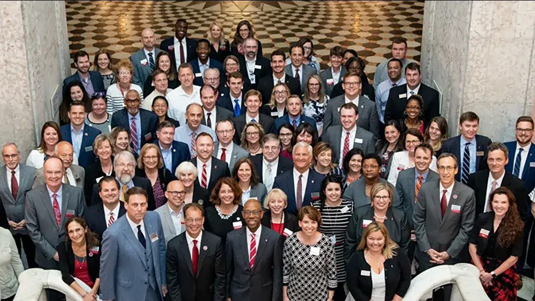 group of buckeye advocates stand at the bottom of a grand staircase