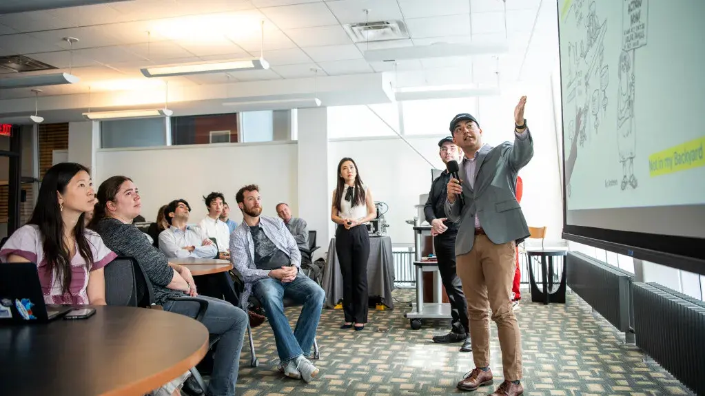 Students presenting collaborative class projects to classmates and industry partners in the John Glenn School of Public Affairs.