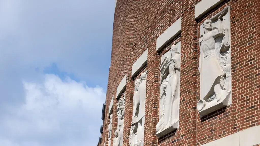 The Ohio Union limestone reliefs by artist Marshall Frederick on the south side of the building on a summer day.