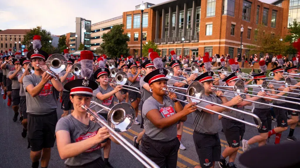 Marching Band in the Homecoming Parade along College Road near the Ohio Union.