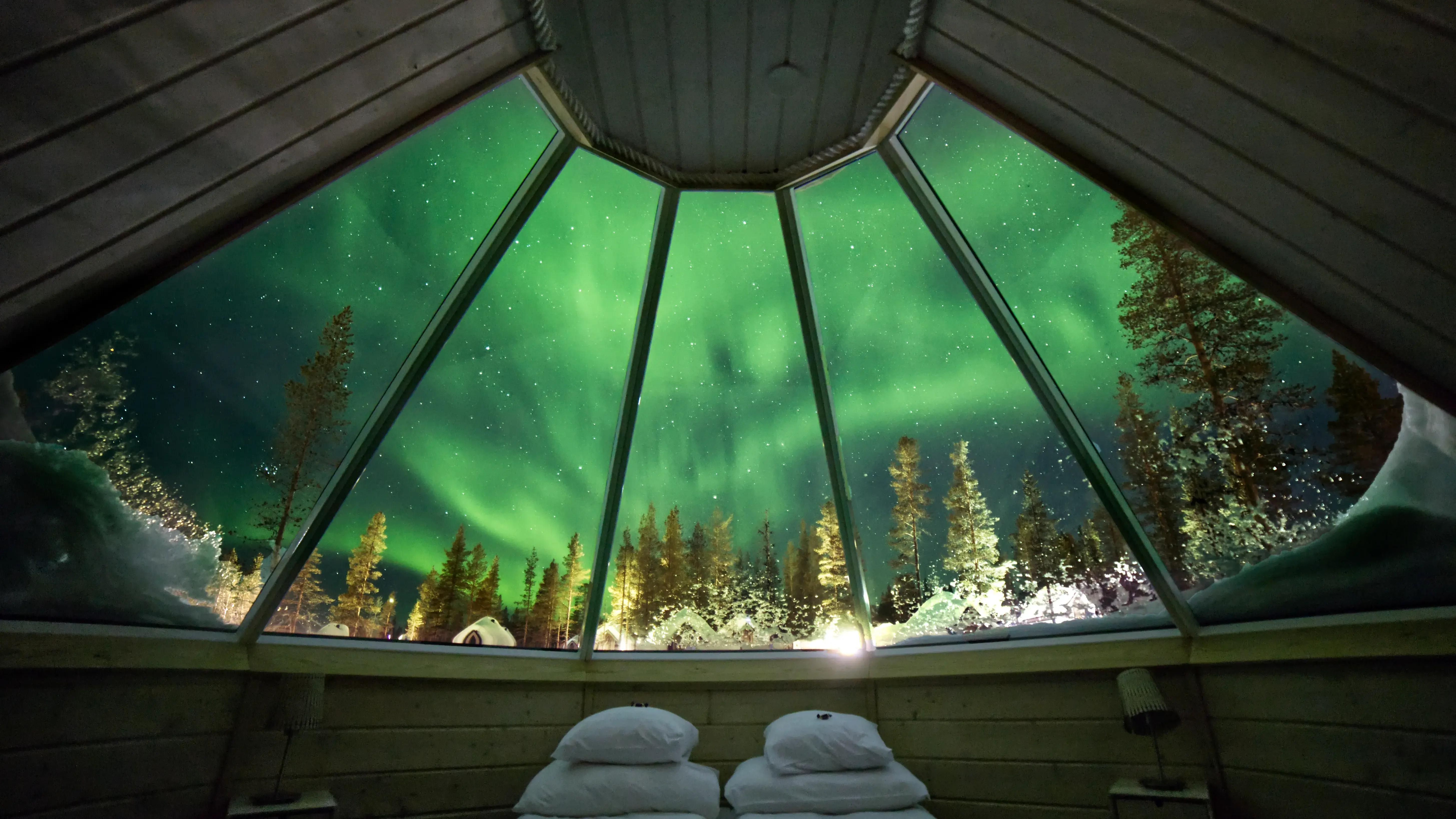 View of the Northern Lights from inside a cabin