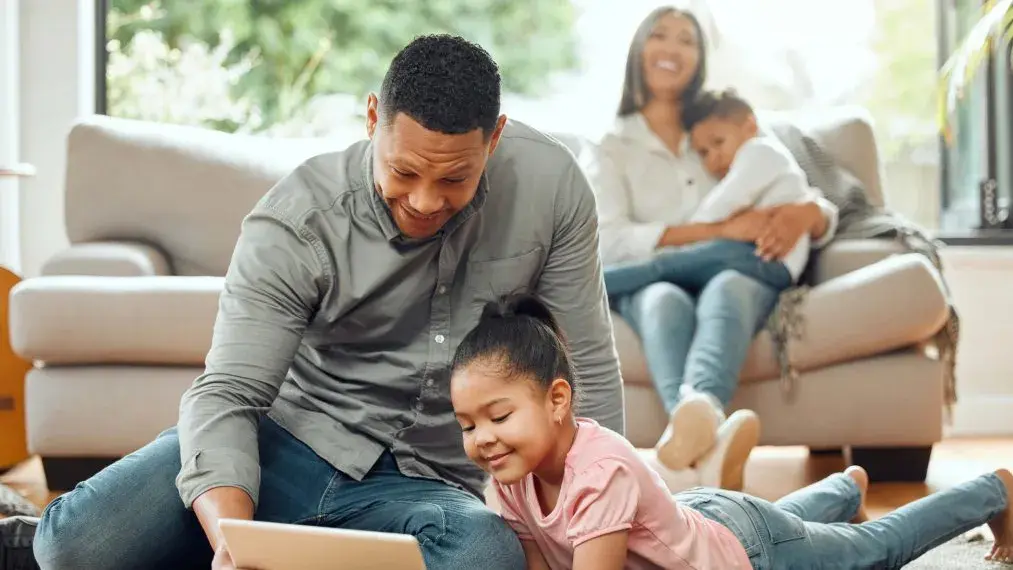 A family in their living room laughing and relaxing