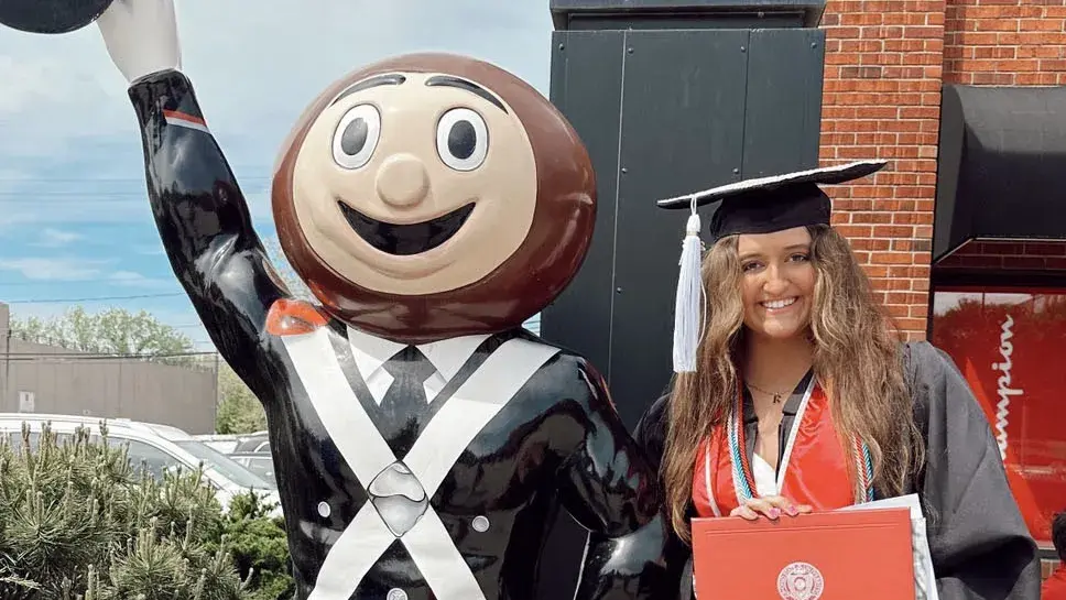 Riley Adleta posing with Brutus statue