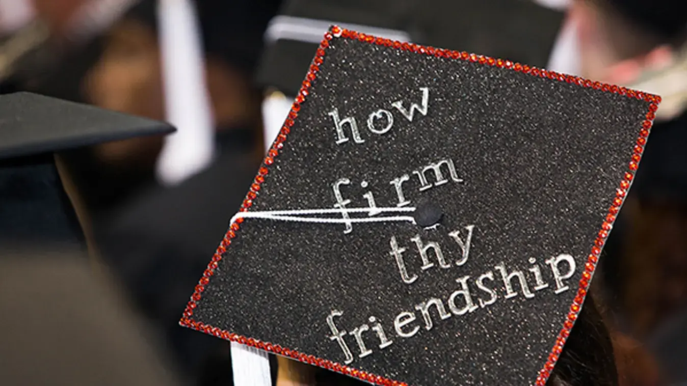 Graduation cap with How firm thy friendship written on it