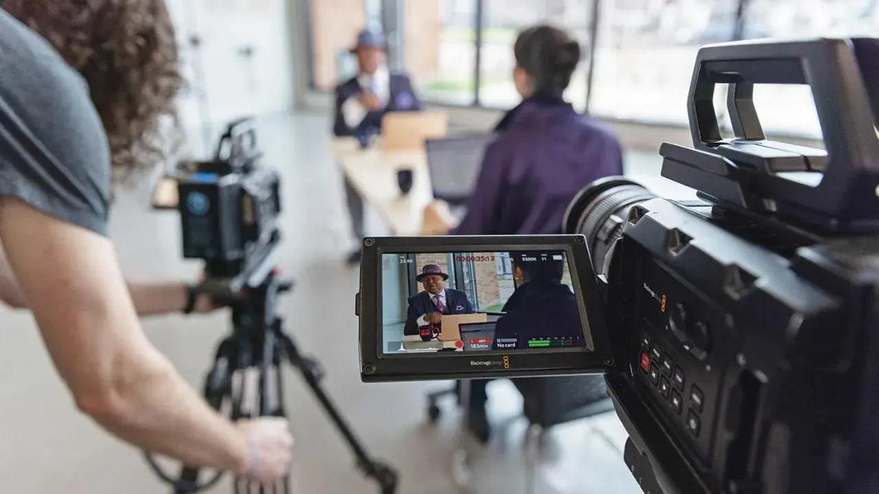 camera person records an interview