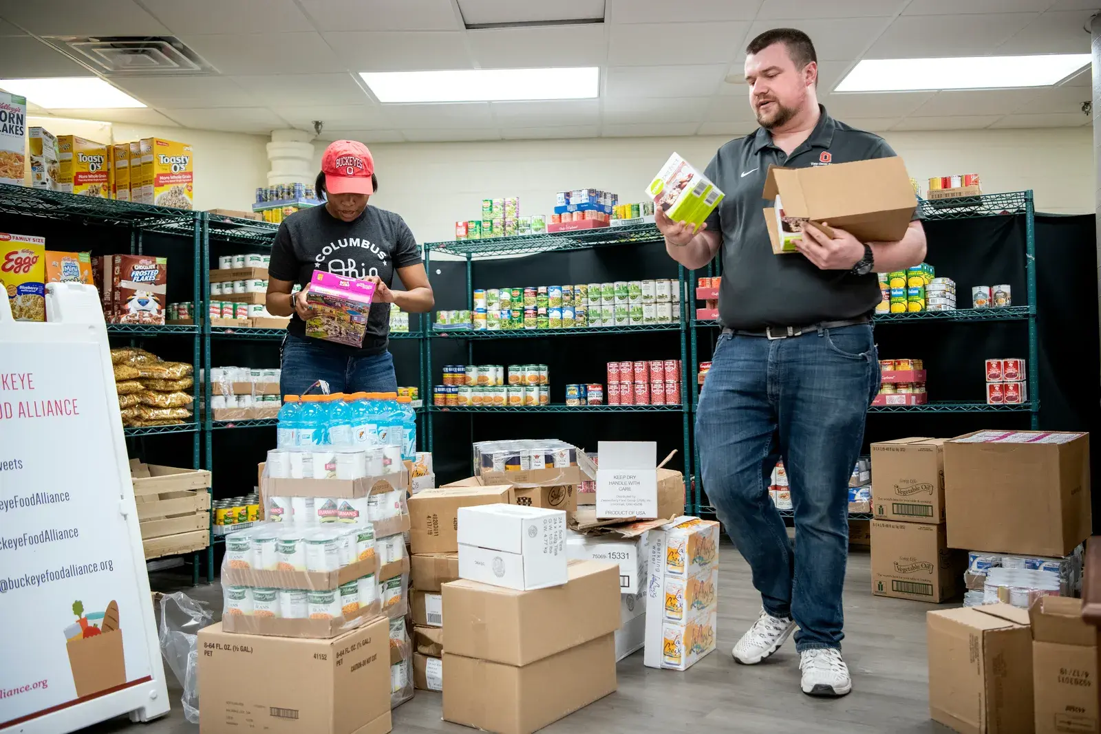 Buckeyes sorting food and boxes in a food pantry