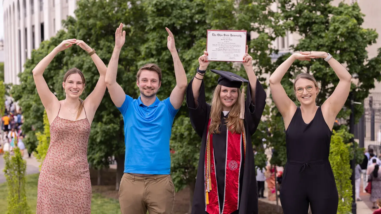 four people pose for o-h-i-o photo