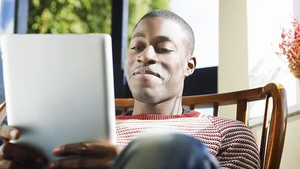 man watches video on an ipad