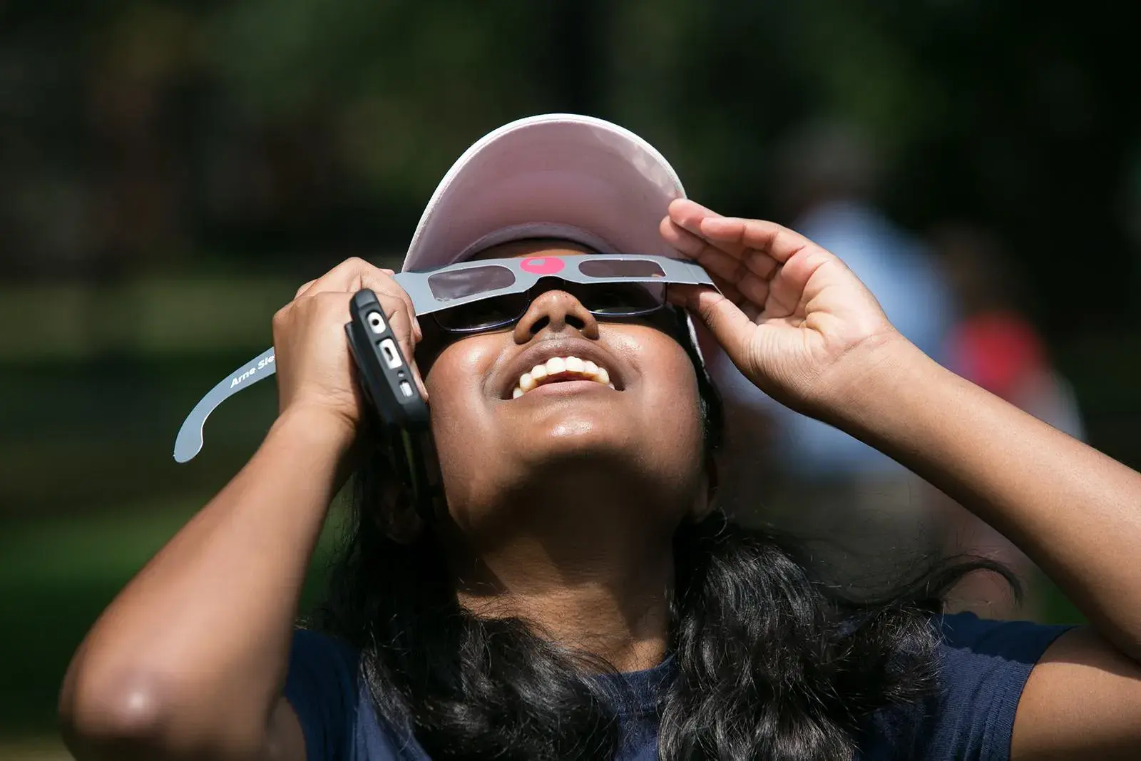 person wearing solar eclipse glasses