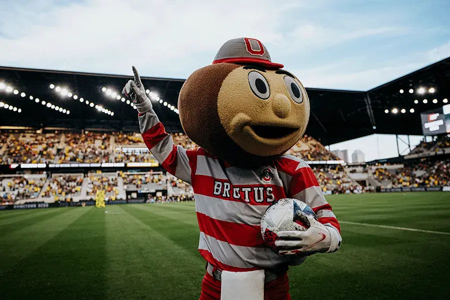 Brutus on the field at a Crew game cheering to the crowd