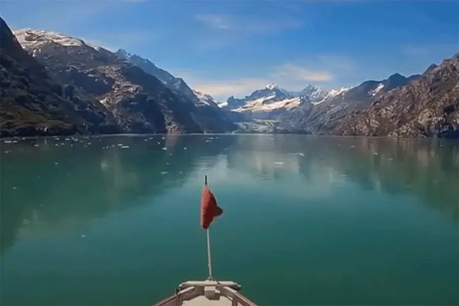 Ship sailing through calm Alaskan waters