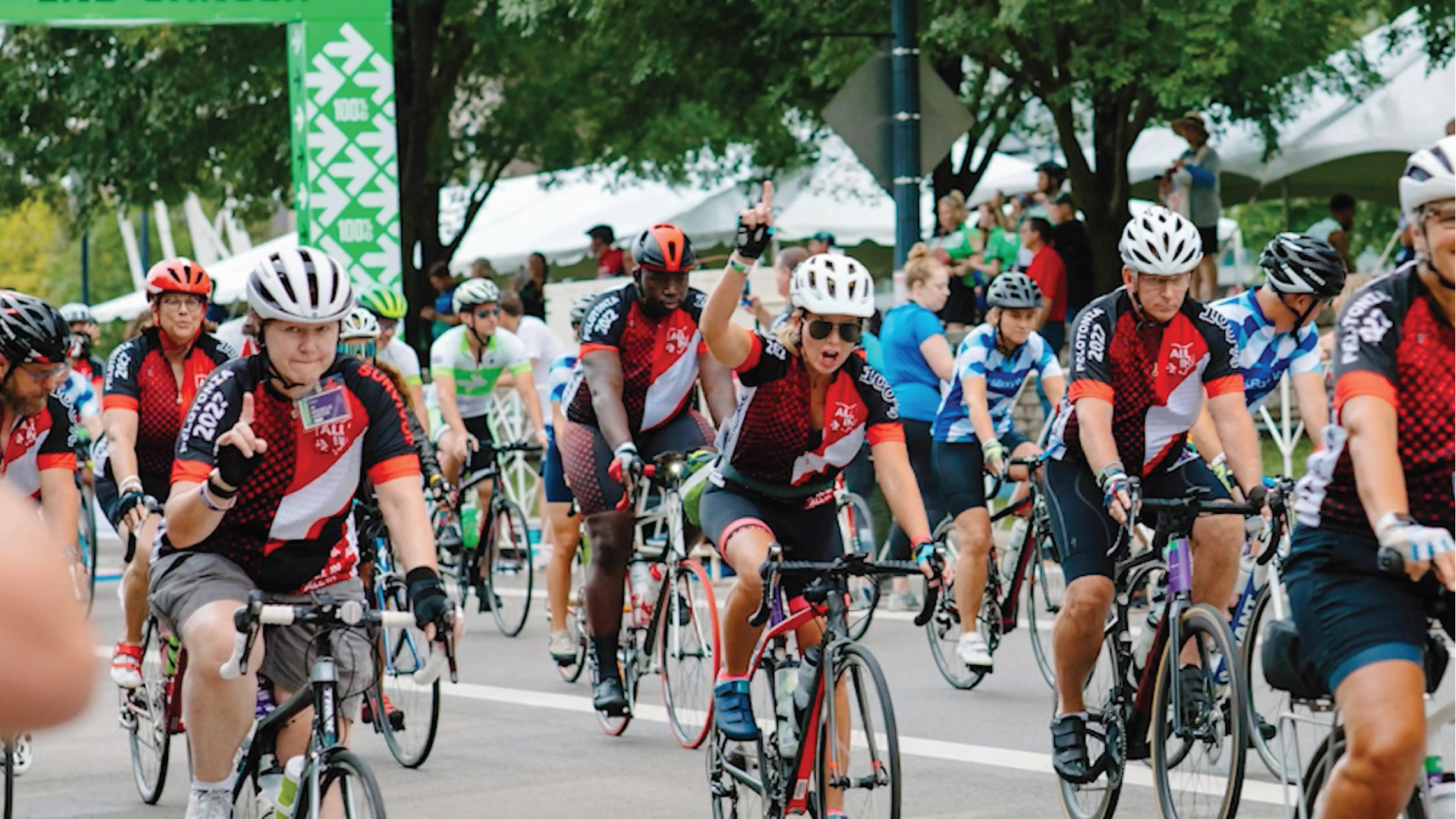 bike riders pedal across the finish line