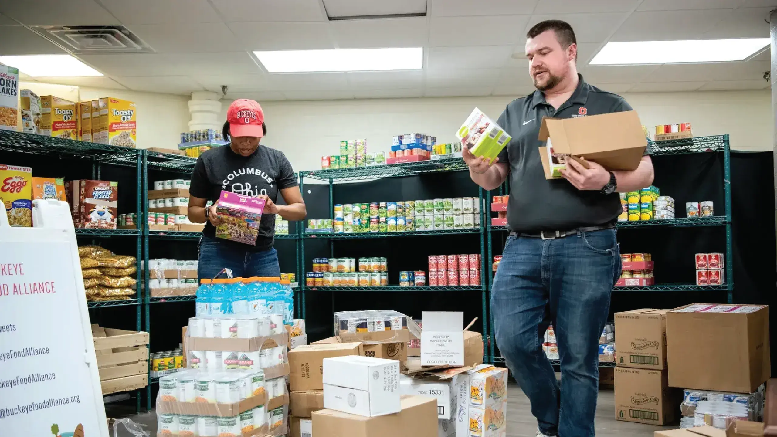 two volunteers working in a food pantry