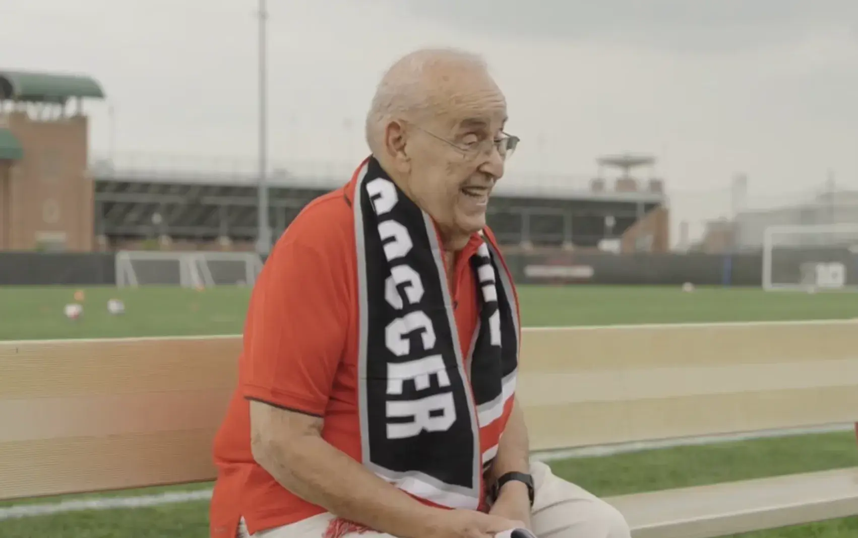 Paul Halpern sitting on a bench near the field