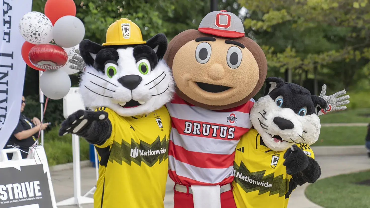 Mascots Brutus Buckeye, Crew Cat and S.C. pose arm in arm