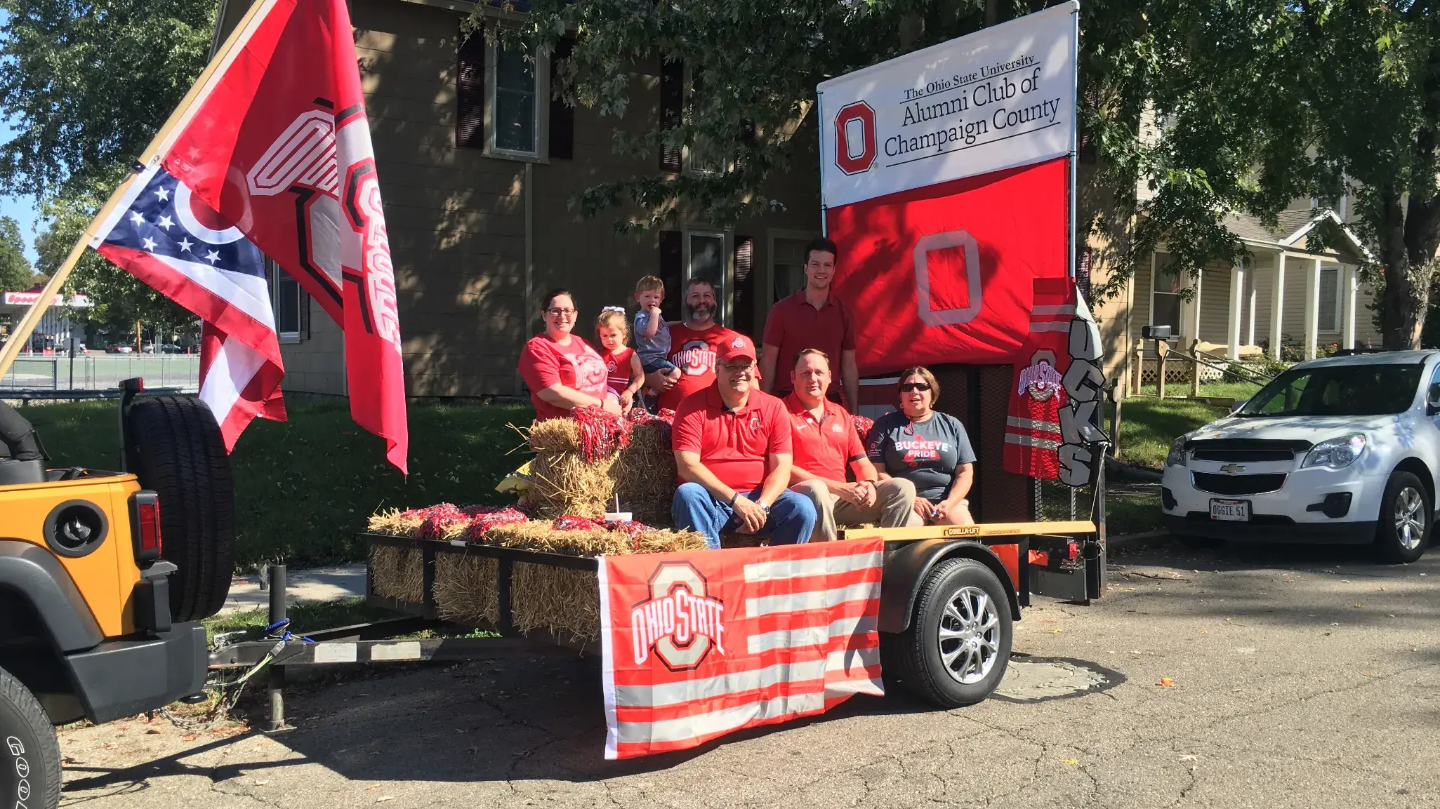 ohio state alumni riding on an ohio state themed float in a parade