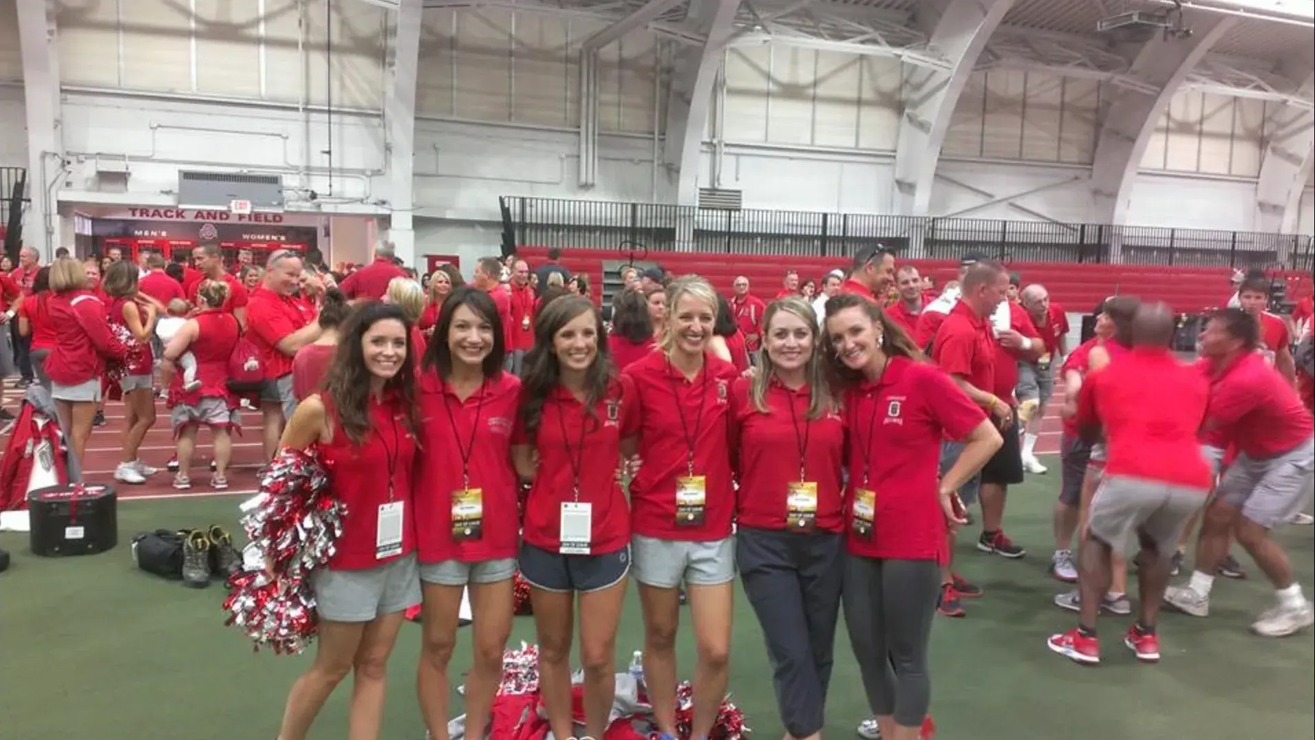 ohio state cheerleaders posing for a picture on a field indoors