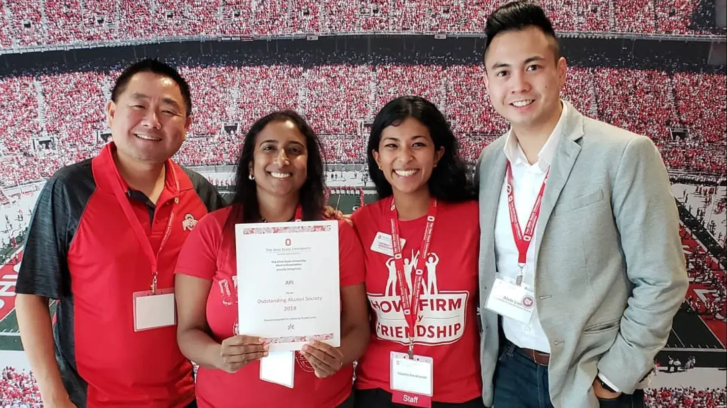 four ohio state alumni holding a certificate of excellent for the asian, pacific and islander society 