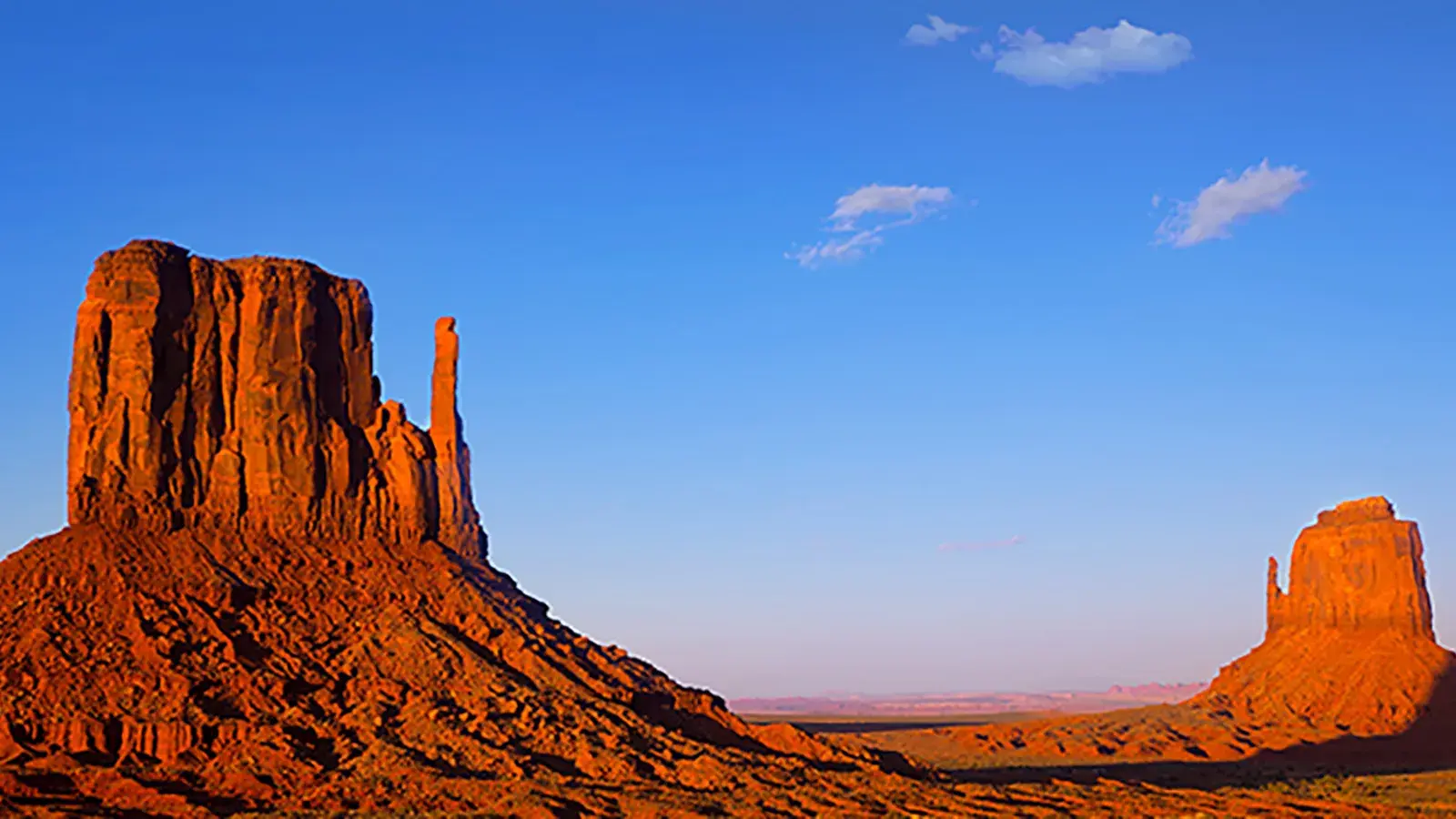 utah sky with red mountains rising out of the desert