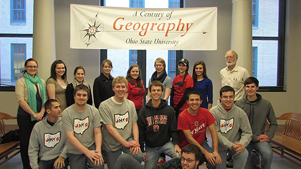group of ohio state alum pasing for a picture indoors