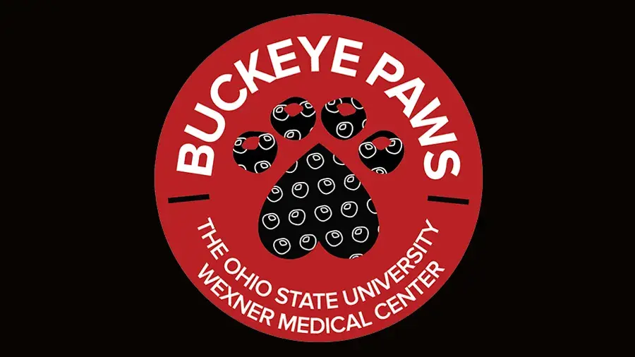 Dog paw print covered with Buckeyes with text reading Buckeye Paws The Ohio State University Wexner Medical Center
