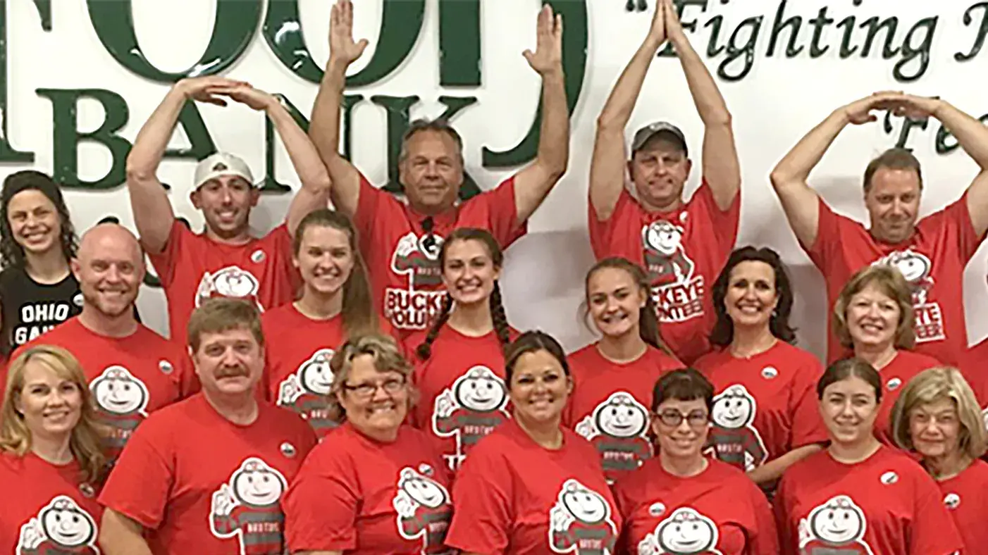 osu alumni volunteering in oklahoma pose in red osu t-shirts