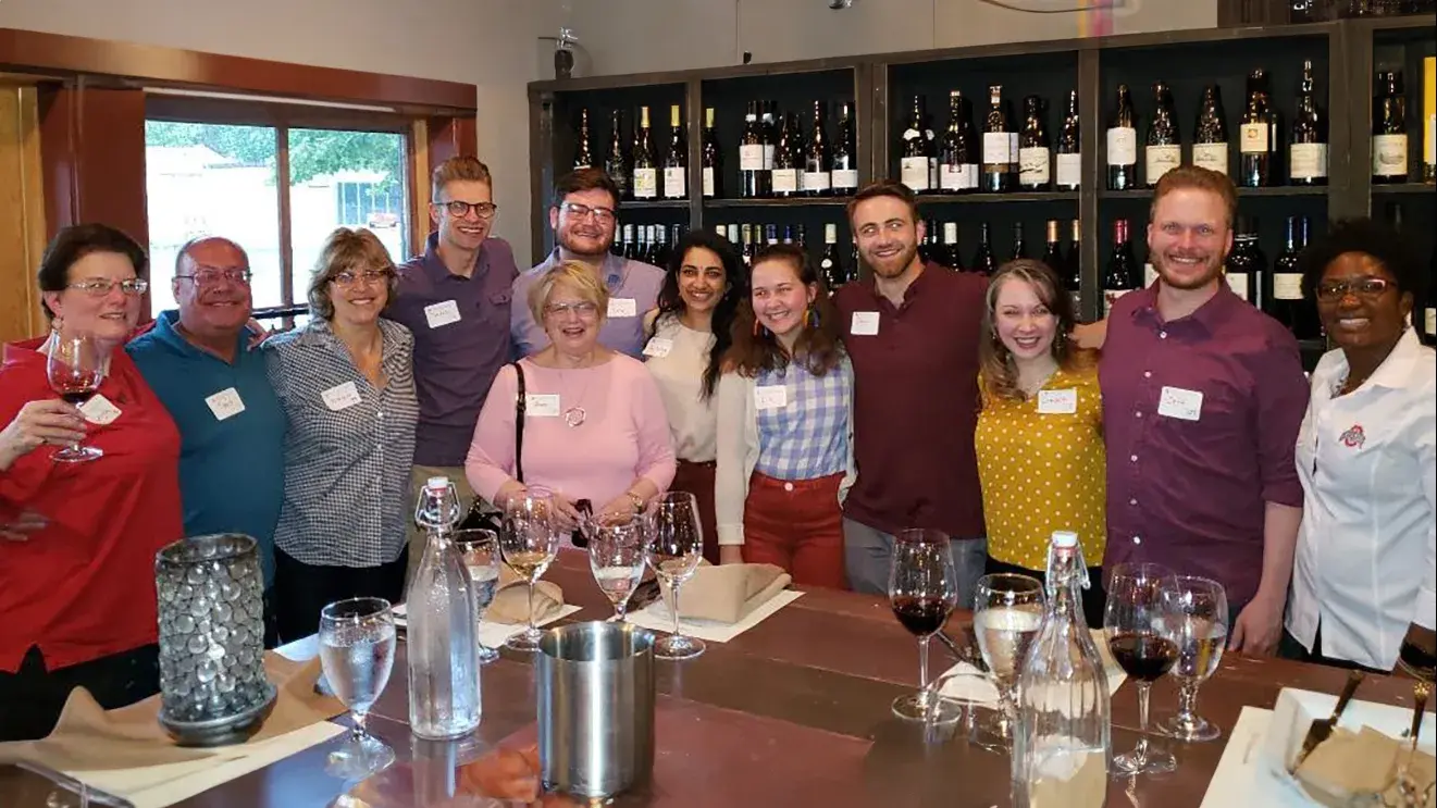 ohio state alumni posing for a photo in a wine bar