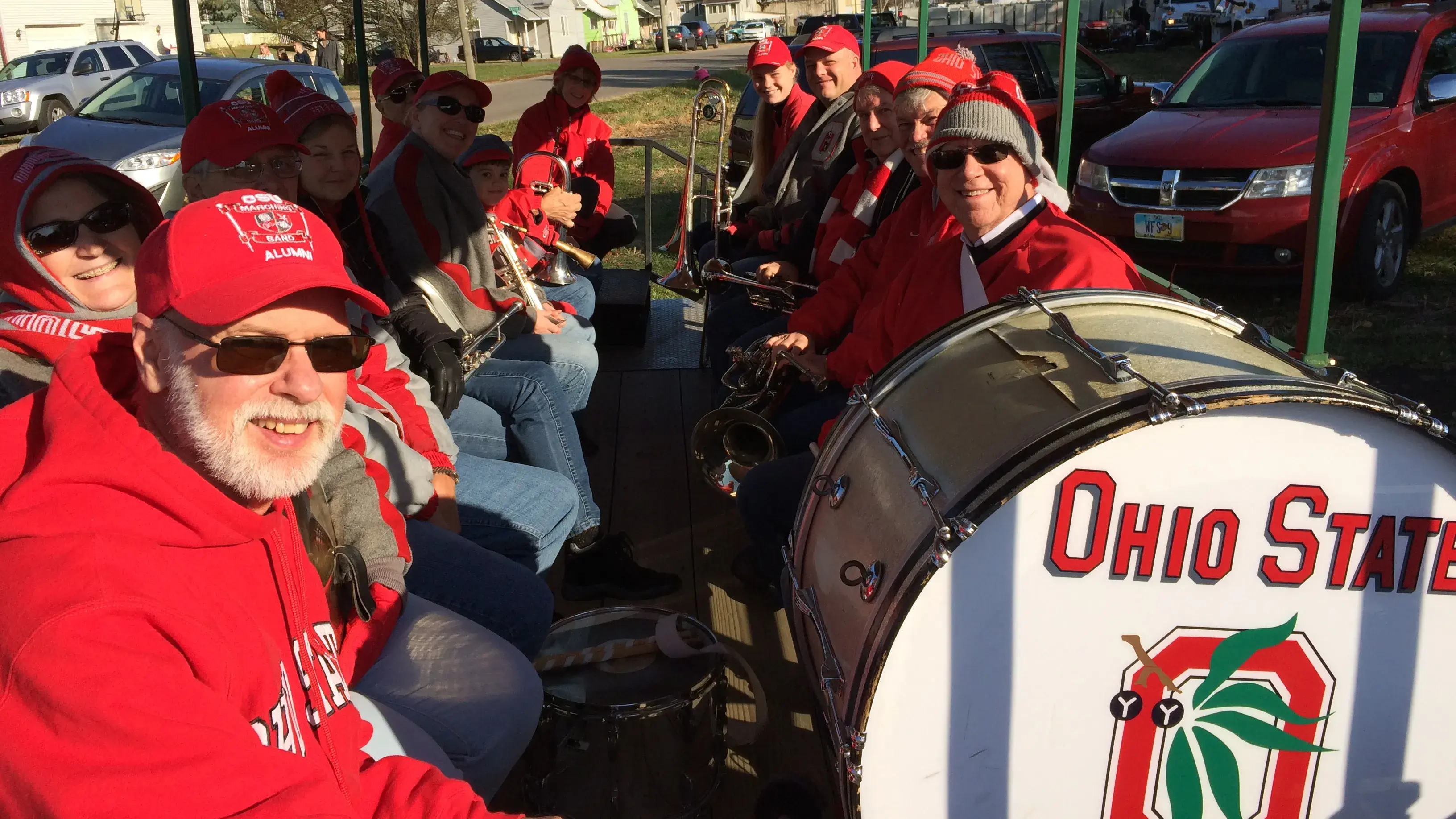 group of alumni band members sitting on a parade float
