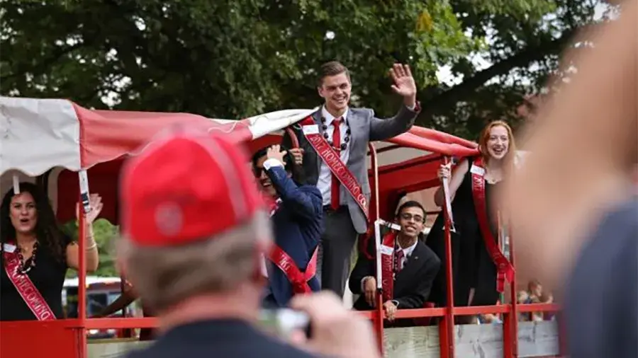 homecoming court riding a float during the parade