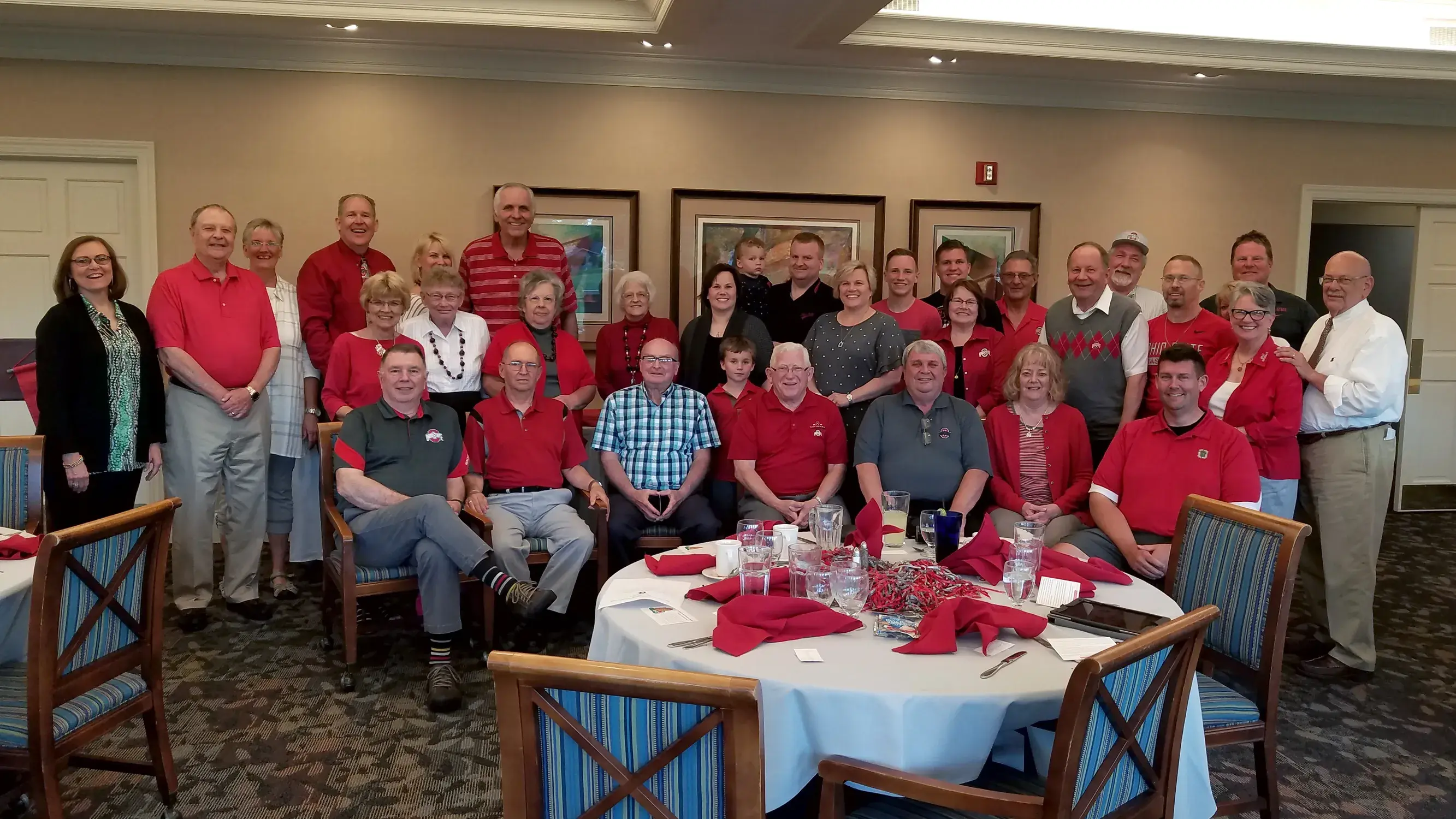 large group of ohio state alumni gather for a picture in a dining hall