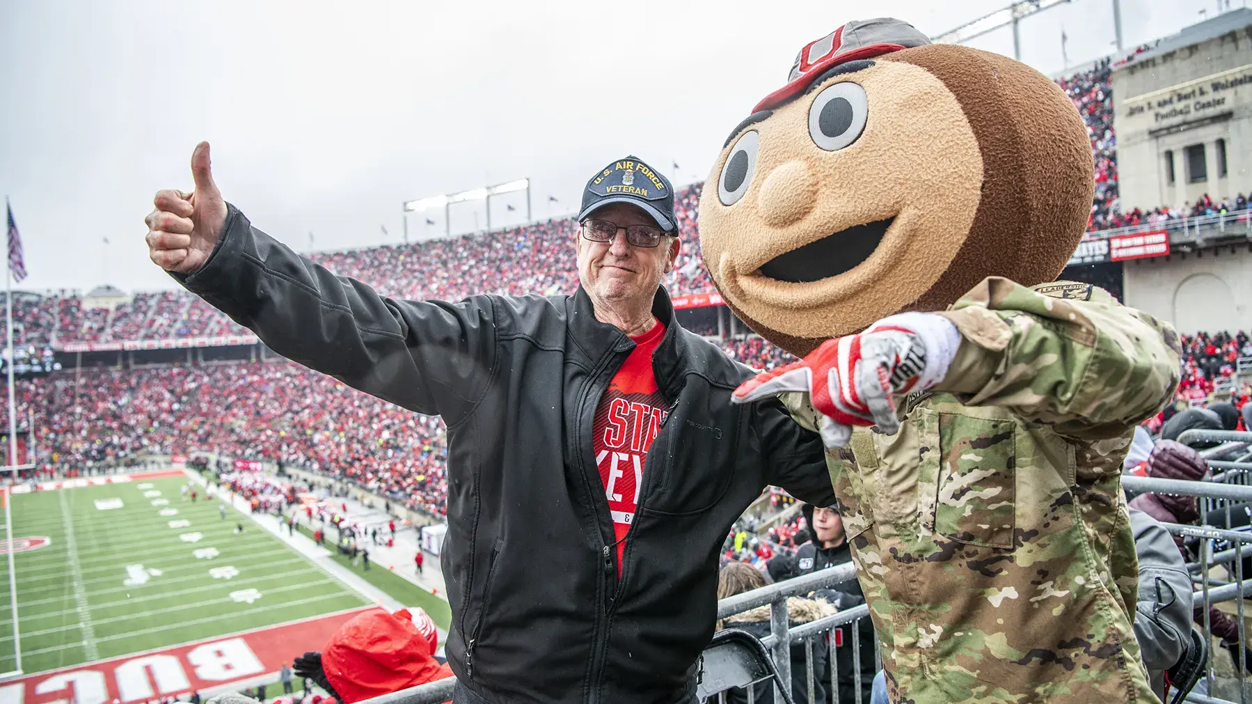 air force veteran gives a thumbs up with Brutus Buckeye